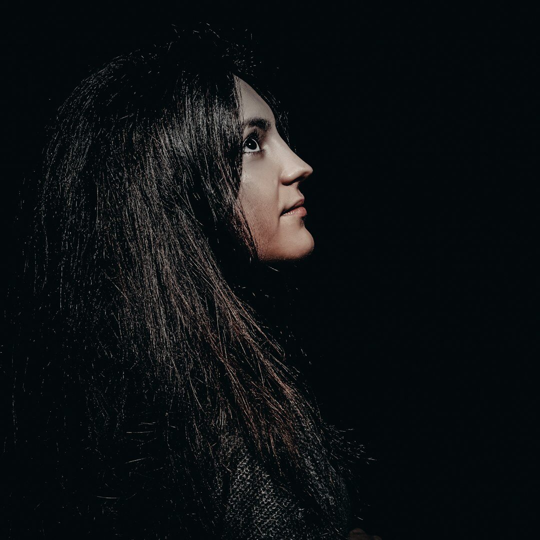 Studio portrait of a Portuguese woman with long dark hair smiling