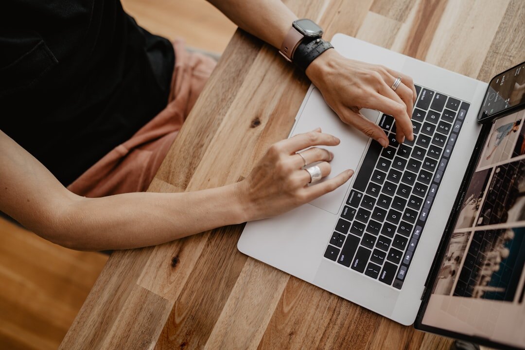 blogger typing on laptop