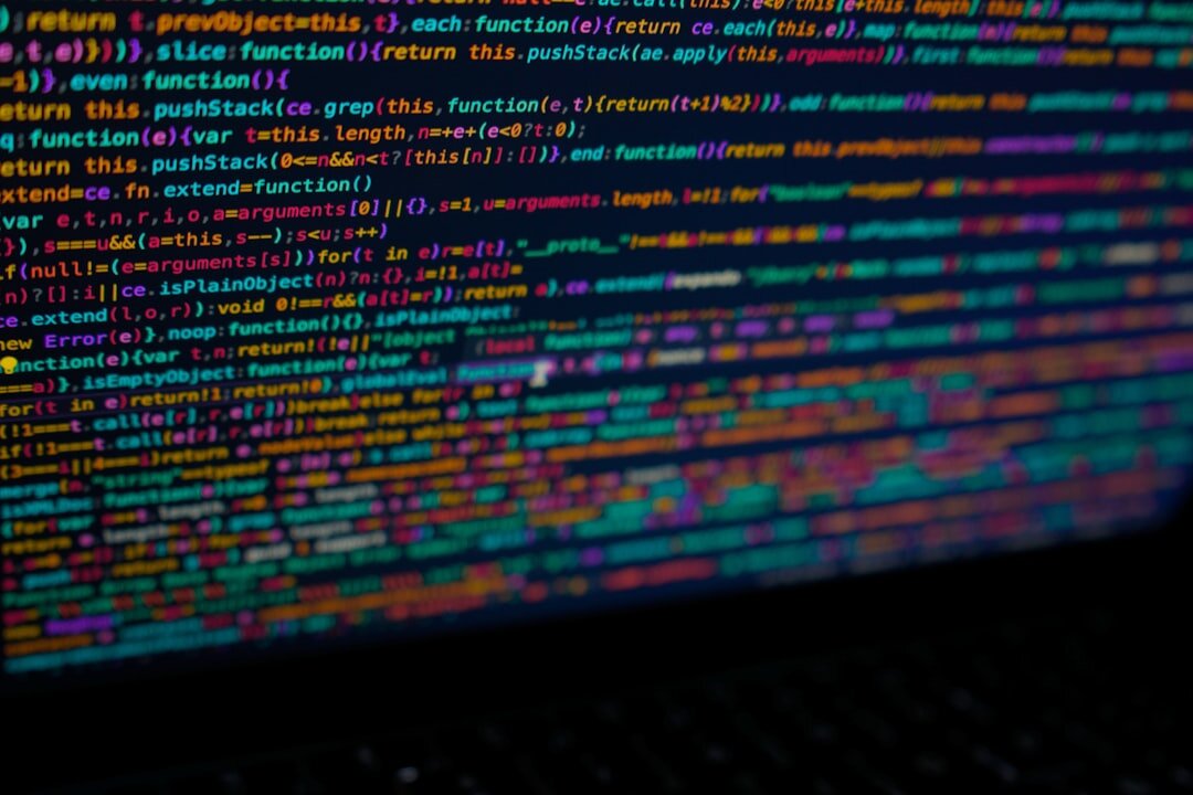 Close-up of a laptop screen showing colorful lines of source code