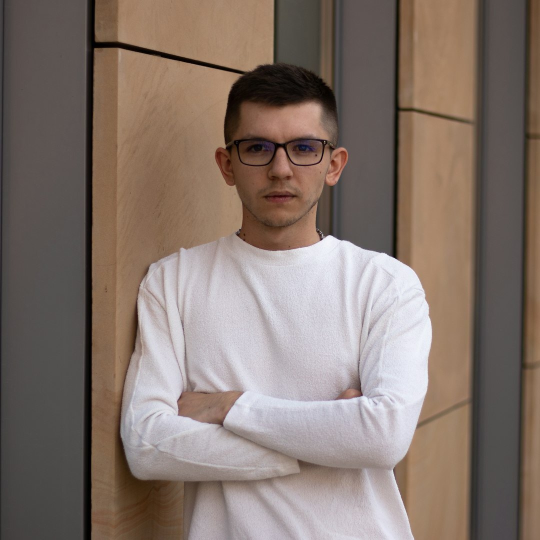 Studio portrait of a young Portuguese man with glasses