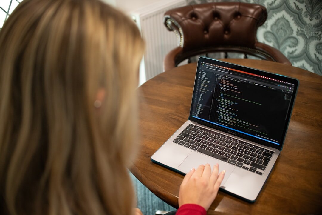 blogger coding on laptop
